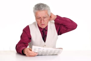 old guy with newspaper at table on white