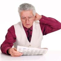 old guy with newspaper at table on white